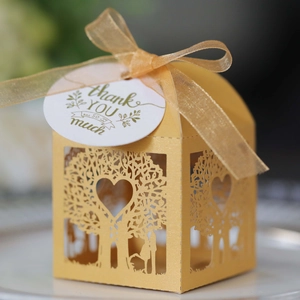 Laser cut heart tree candy box in gold pearlescent paper with ribbon and tag