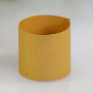 Macro detail of golden napkin ring showing fine glitter texture and pearl finish surface