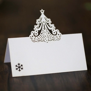 Laser cut white Christmas tree place cards for holiday wedding table decor