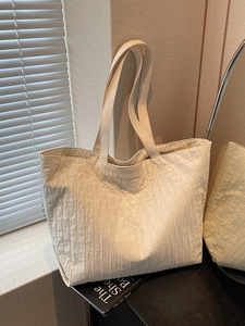 Minimalist beige pleated tote bag with large capacity and stylish texture for daily commute