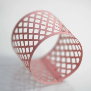 Detailed macro view of pink hollow diamond mesh candle holder with lattice pattern