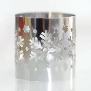 Macro shot of silver snowflake cutout napkin ring with a polished metallic mirror finish