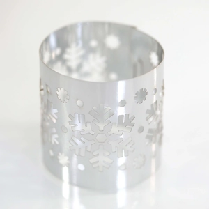 Close-up of silver metal napkin ring with hollowed-out snowflake pattern for Christmas
