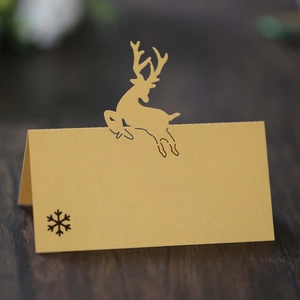 Champagne gold laser-cut reindeer place cards for wedding and Christmas party tables