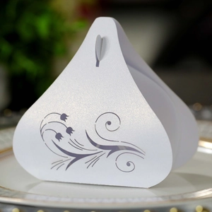 Close-up of white tulip hollow wedding candy box on elegant gold rimmed plate