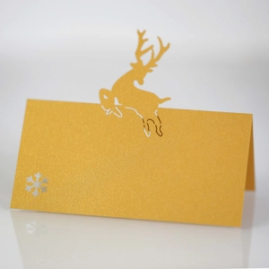 Close-up of golden reindeer and snowflake cutout design on foldable place card