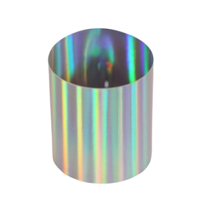 Macro detail of cylinder napkin ring with shimmering golden holographic laser texture
