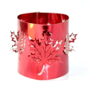 Close-up of red maple leaf laser-cut hollow candle cover with metallic finish