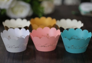 Detailed view of hollow cupcake wrappers with wave edges and gold Cake Play printing