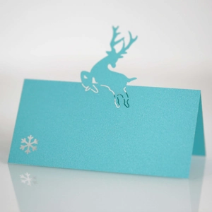 Detail of laser-cut light blue deer place card with silver snowflake and shimmer finish
