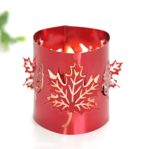 Detailed view of red metal maple leaf hollow lampshade with warm glowing light effect