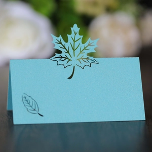 Macro detail of laser-cut maple leaf place card in sky blue pearlescent paper finish
