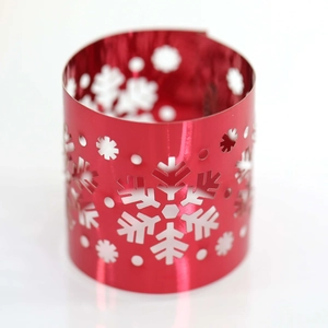 Close-up of red mirror finish snowflake hollowed napkin ring with festive laser cutouts