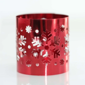 Detail of red metal snowflake napkin ring with precision laser-cut hollowed patterns
