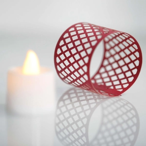 Macro shot of red hollow geometric grid lampshade for electronic candles and party decor