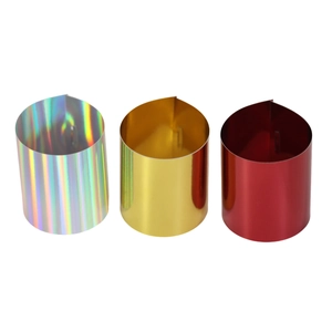 Close-up of three shimmering metallic napkin rings in gold, silver and red finishes