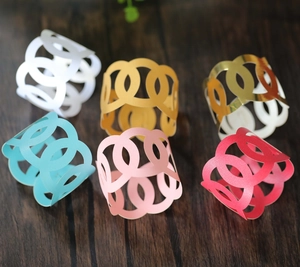 Laser-cut hollow interlocking oval paper napkin rings in six vibrant metallic colors