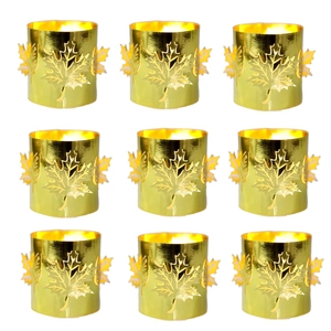 Macro detail of golden hollow maple leaf candle holders with warm light effects