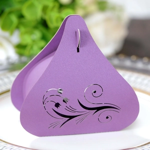 Detail of laser-cut tulip patterns on purple triangular wedding candy gift box