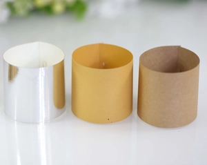Detail of glitter gold, silver, and kraft paper napkin rings for restaurant dining