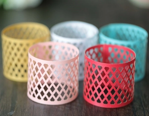 Detailed view of hollow geometric laser-cut cardstock ring set in five vibrant colors