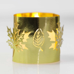 Detail of golden maple leaf hollow lampshade showing warm light through metal cutouts