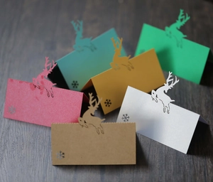 Close-up of laser-cut reindeer and snowflake place cards in assorted paper colors