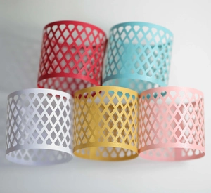Set of five colorful laser-cut hollow diamond pattern paper candle holders and napkin rings