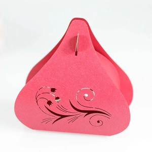 Detail of red wedding candy box featuring intricate laser-cut tulip flower patterns