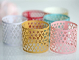 Detailed view of colorful laser-cut hollow diamond pattern paper napkin rings in various colors