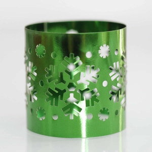 Macro detail of glossy green metallic snowflake hollowed-out candle holder wrap