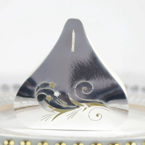 Close-up of laser-cut tulip pattern on silver wedding candy box with top slot detail