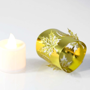 Detailed close-up of golden laser-cut maple leaf candle holder with metallic finish