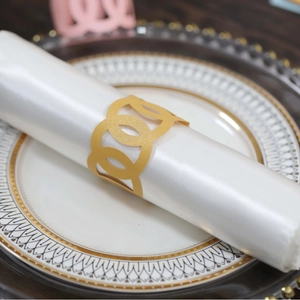 Elegant gold triple-ring interlocking napkin holder on silk napkin for upscale dining