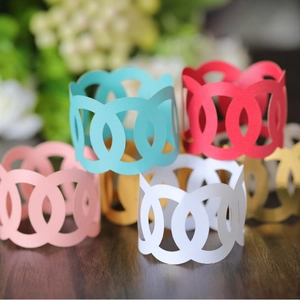 Laser cut paper napkin rings in diverse colors for elegant hotel dining table settings