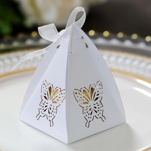 Detail of white laser-cut butterfly gift box with gold liner and elegant ribbon
