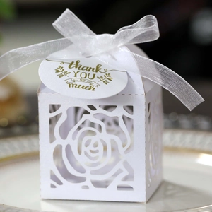 Detailed laser-cut rose hollow favor box with white ribbon and thank you tag