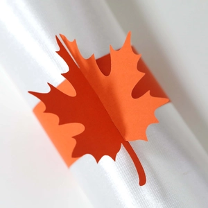 Detail shot of orange maple leaf paper napkin ring with precise laser cut edges