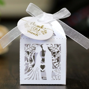 Elegant laser-cut wedding candy box with silhouette motif and white organza ribbon