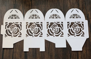 Detailed laser-cut white cardstock template featuring intricate rose patterns for gift boxes