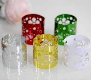 Detailed laser-cut snowflake napkin rings in gold, silver, red, green, and white colors