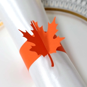 Macro view of a 3D orange maple leaf napkin ring for autumn festival table settings