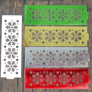 Laser-cut snowflake napkin rings in five colors on dark wood background