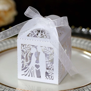 Detail of white laser-cut wedding gift box featuring a bride and groom silhouette and ribbon