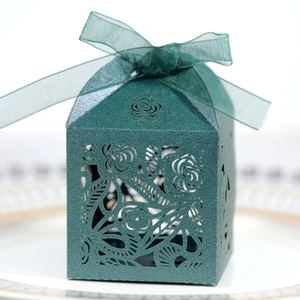 Detailed laser-cut rose patterns on dark green wedding candy box with sheer ribbon