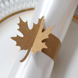 Macro detail of laser-cut maple leaf napkin ring made from natural kraft paper