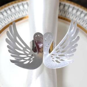 Detailed close-up of a silver swan napkin ring with laser-cut hollow feather patterns