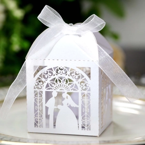 Laser-cut white wedding candy box with bride and groom silhouette and organza ribbon