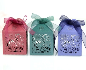 Detailed laser-cut floral gift boxes in burgundy, green and purple with organza ribbons
