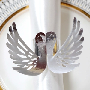 Close-up of elegant silver swan napkin ring with hollow wings for table decor